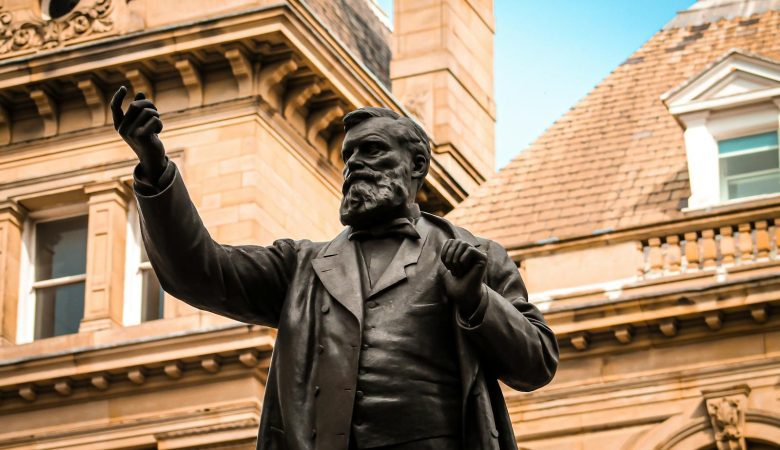 Bronze statue of W.E. Forster in front of historic architecture in Bradford, England. filming locations