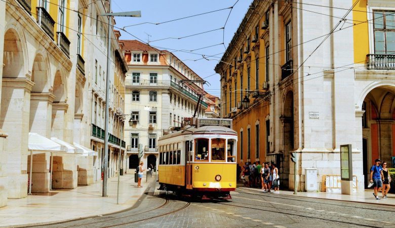 yellow and white tram on road during daytime