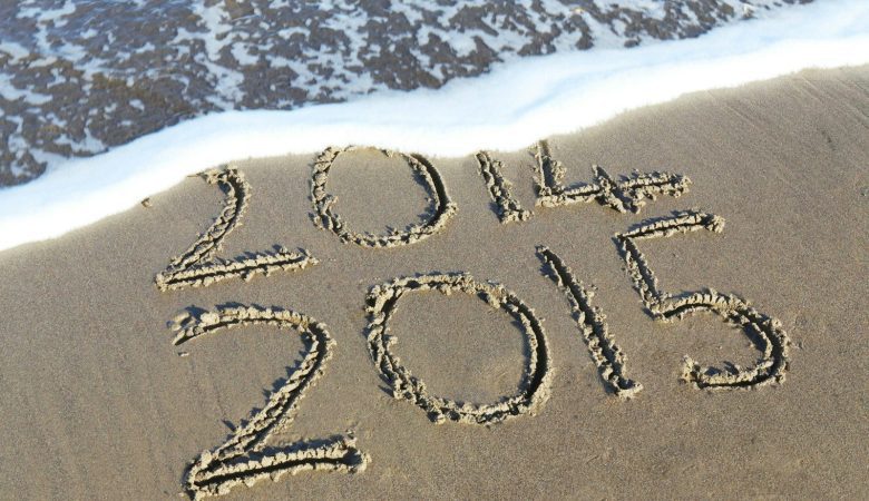beach shore etch with 2014 and 2015 texts during daytime